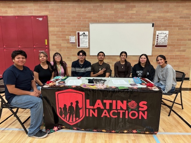 Latinos in Action students helping at back to school night