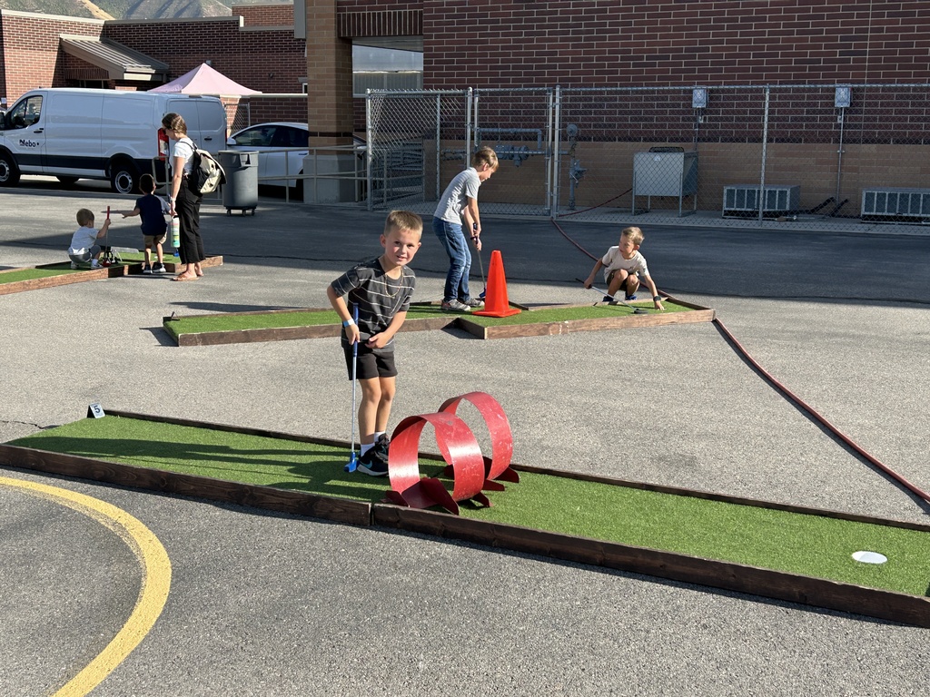 Students playing miniature golf.