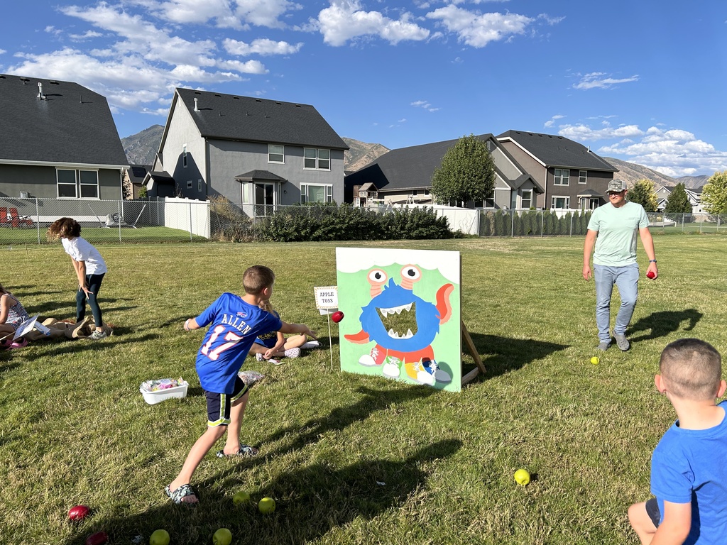 Student playing a bean bag toss game.