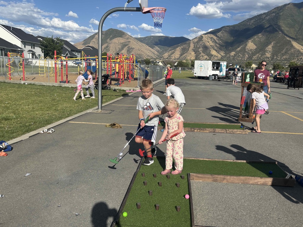 Students playing miniature golf.