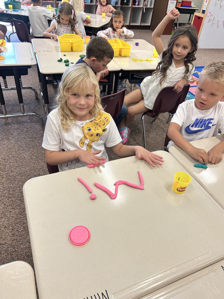 kindergartener spelling name with playdough