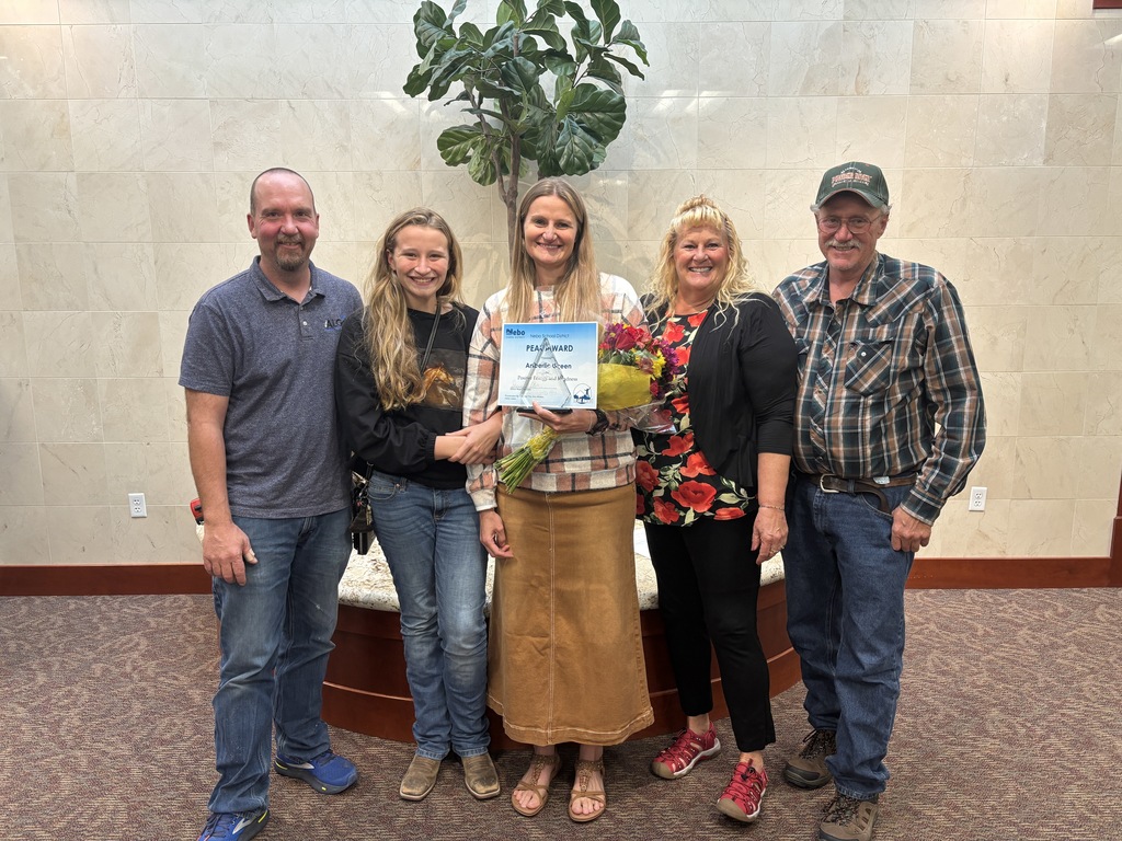 Mrs. Green and her family recieving the peak award