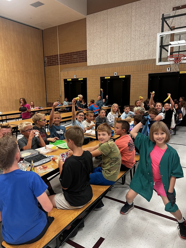 Fourth Grade student showing us their fresh piece of corn on the cob for lunch