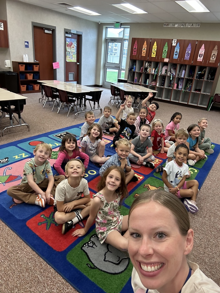 kinder class and teacher smiling