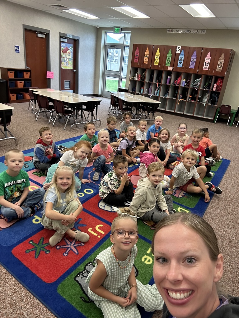 kinder class and teacher smiling