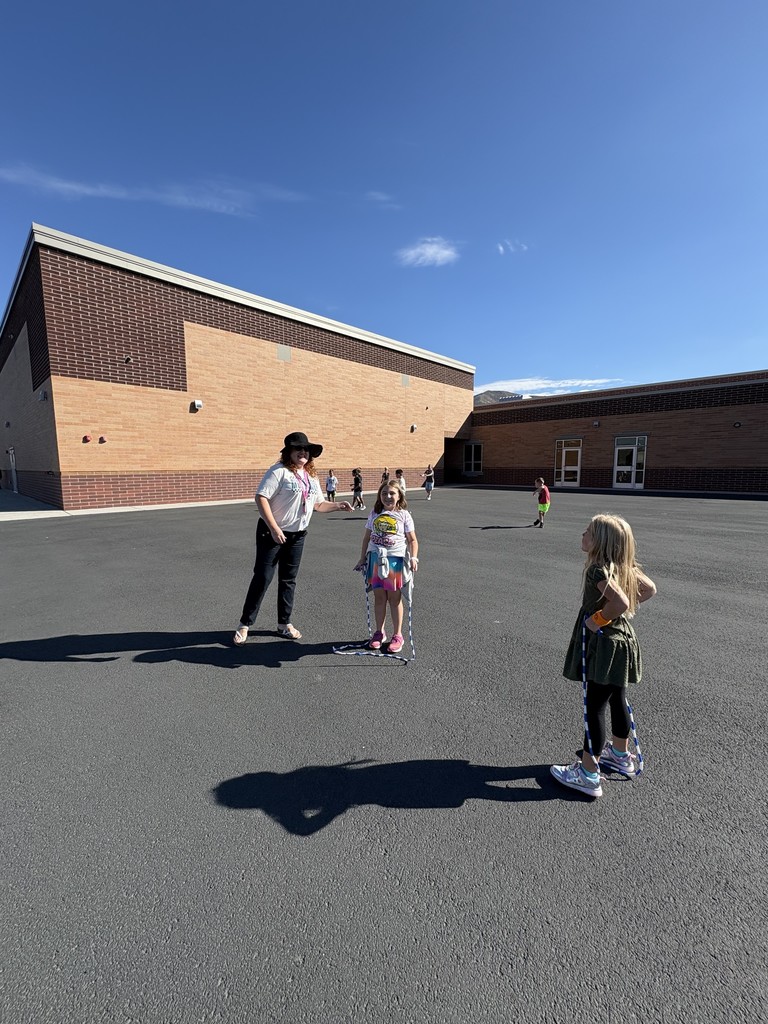 students playing jump rope with a teacher