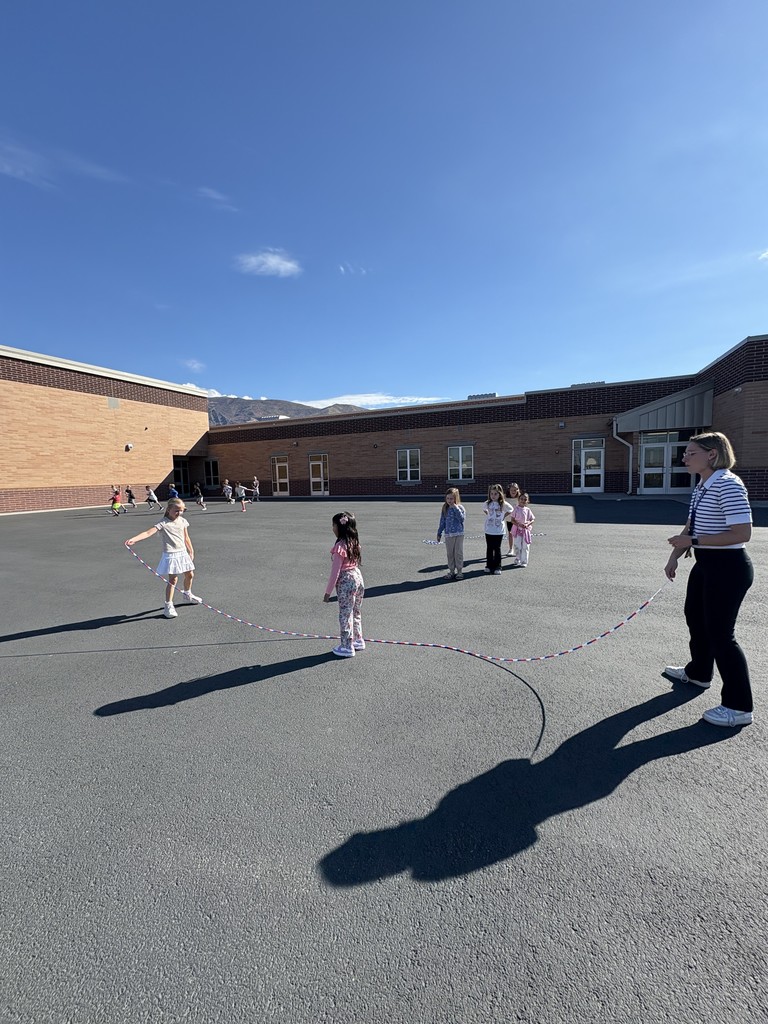 students playing jump rope with a teacher