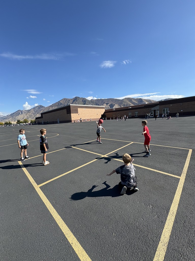 students playing four square