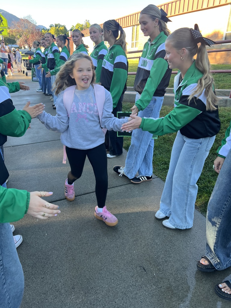 Student high fiving cheerleaders