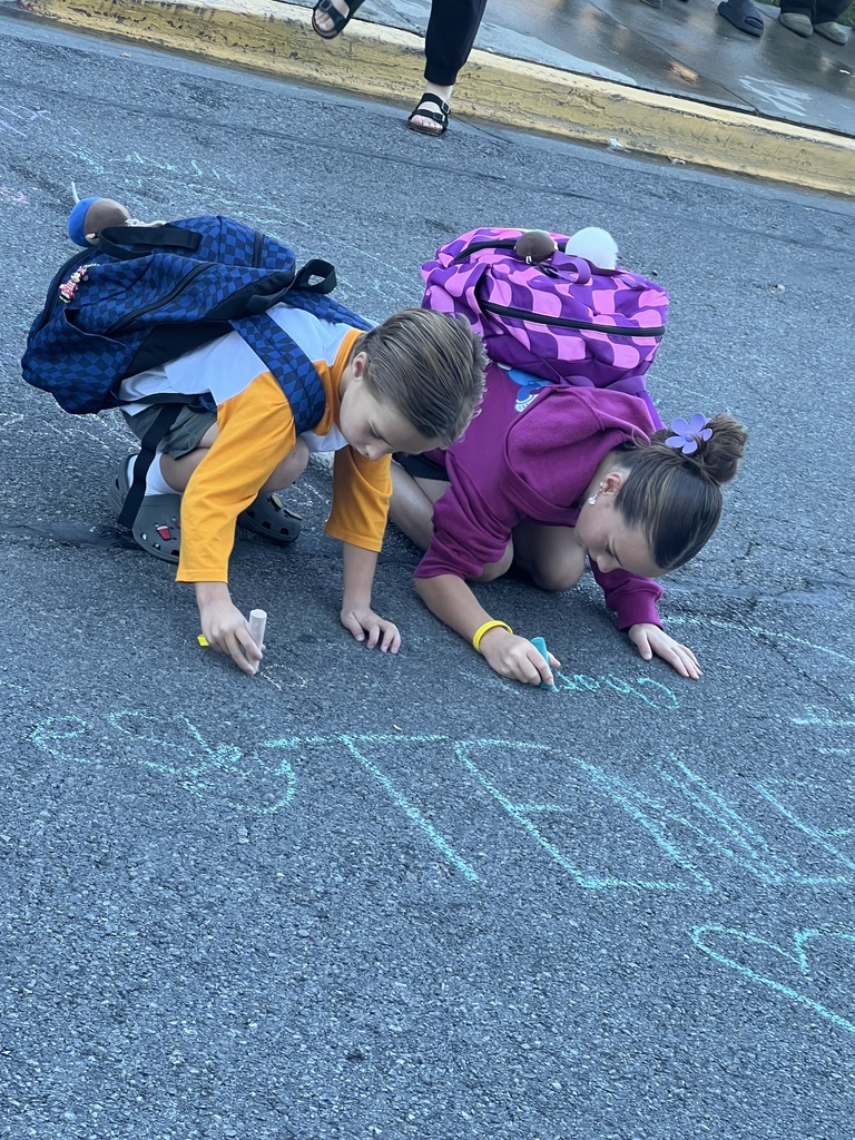 Students writing messages with chalk
