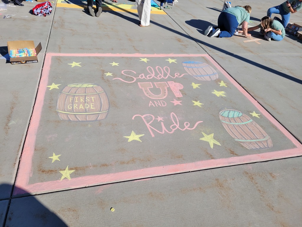 chalk on the sidewalk saying "saddle up and ride"