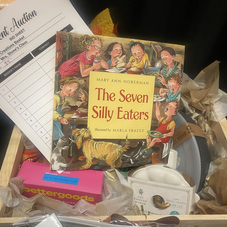a basket with cooking supplies and a book