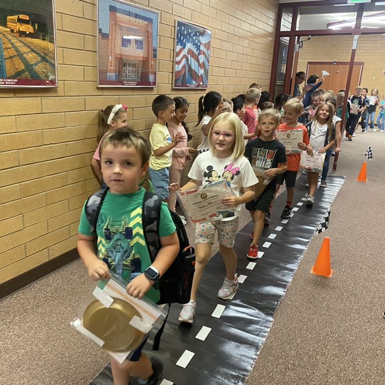 students marching down the hall on a black carpet