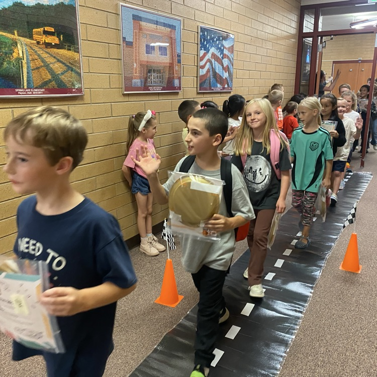 students of the month marching down the hall
