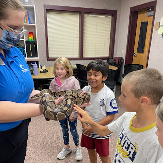 2nd grade students touching a snake