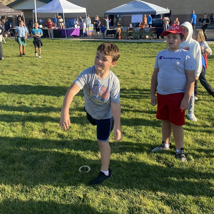 a student mid throw standing in the field