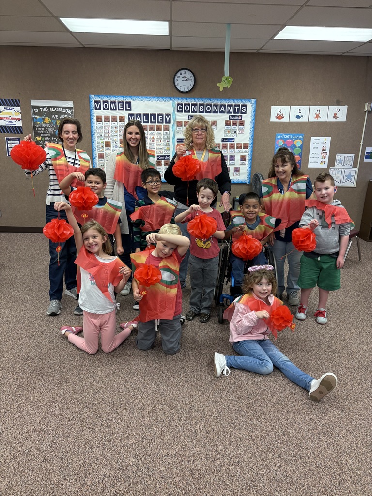 2nd Grade students holding lanterns and are dressed like a Phoenix