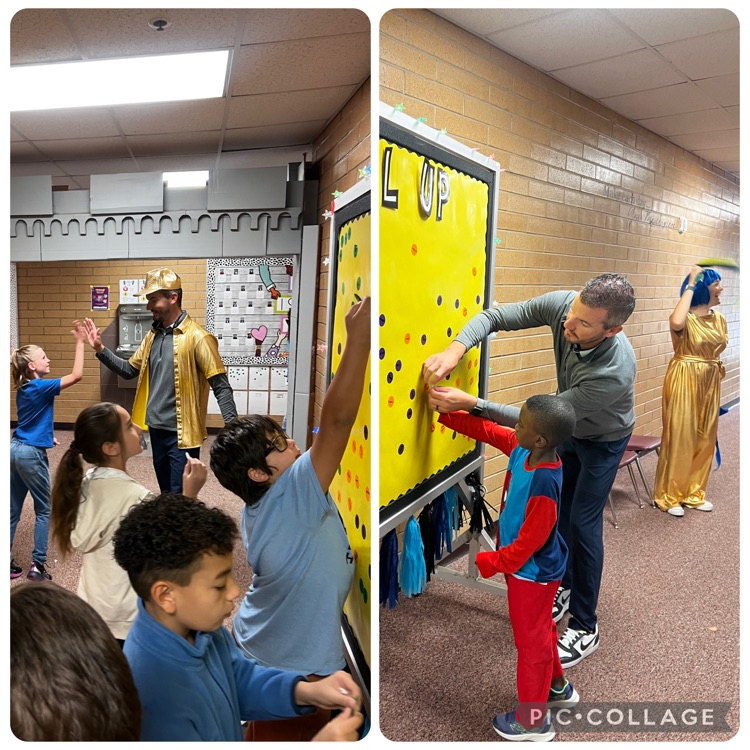 Students placing their Level-up stickers on the Level up board 