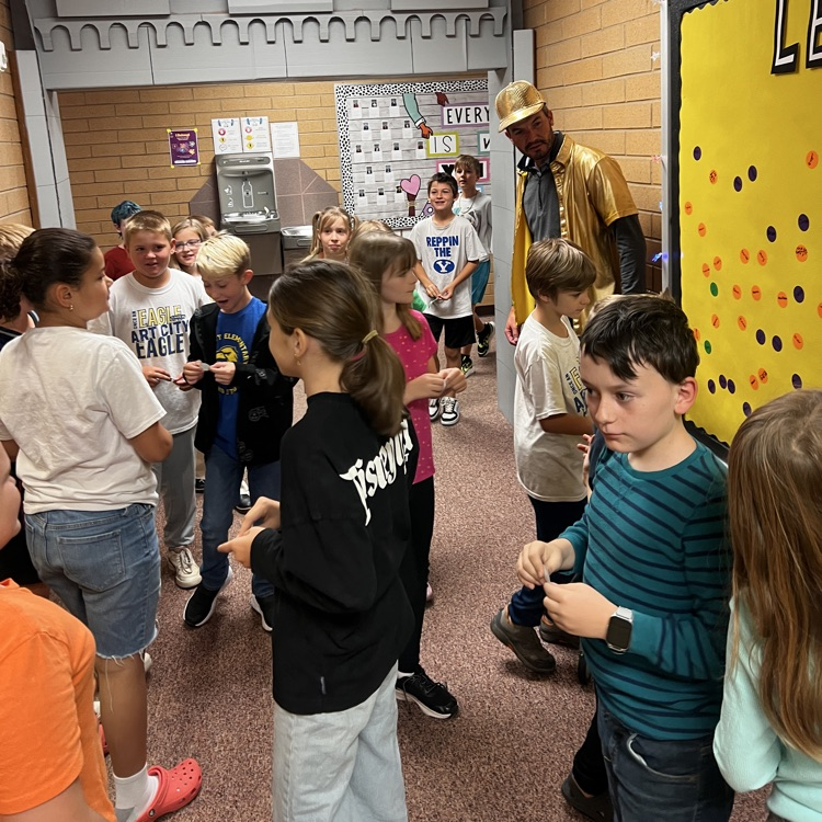 Students placing their Level-up stickers on the Level up board