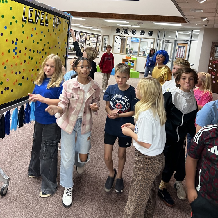 Students placing their Level-up stickers on the Level up board