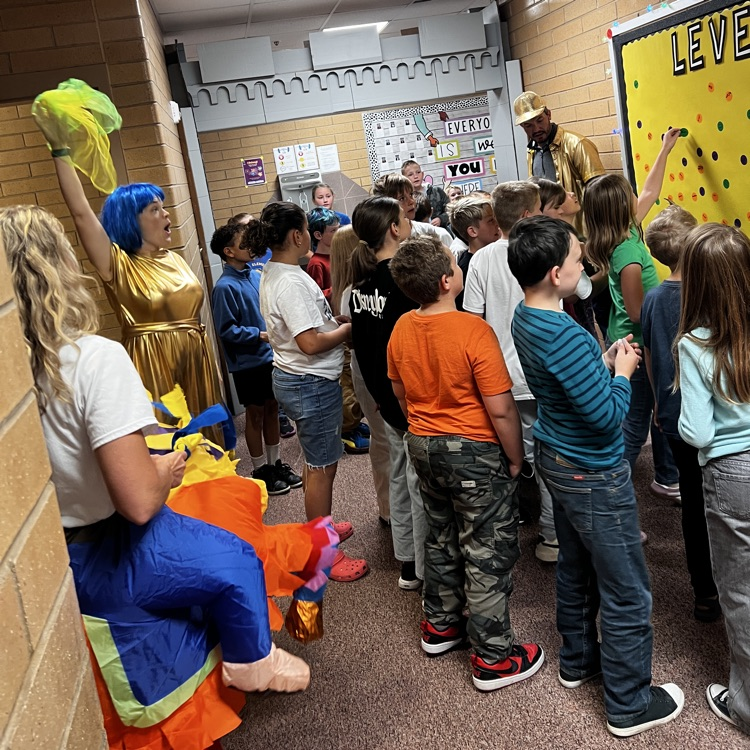 Students placing their Level-up stickers on the Level up board