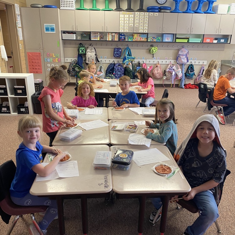 First grade students creating clay tablets 