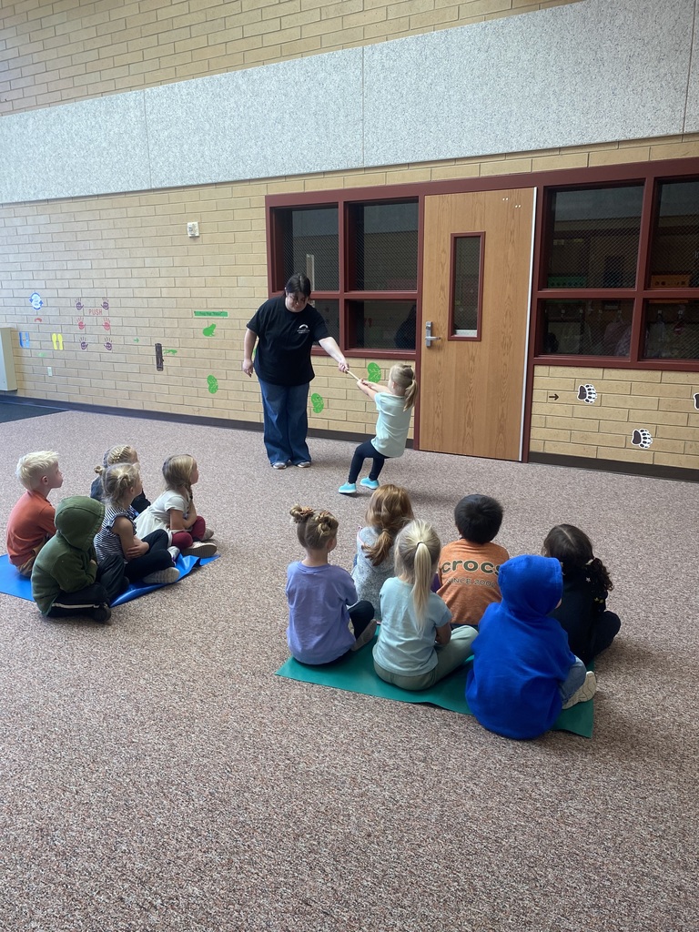 an adult holding one end of a rope while a child pulls on the other end