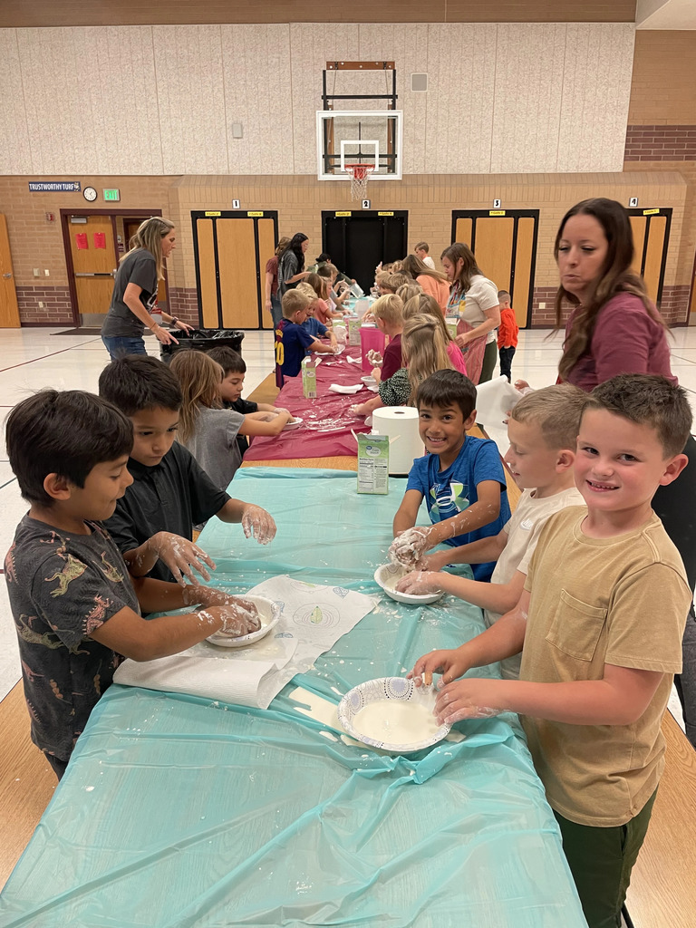 students making oobleck, their hands are a mess