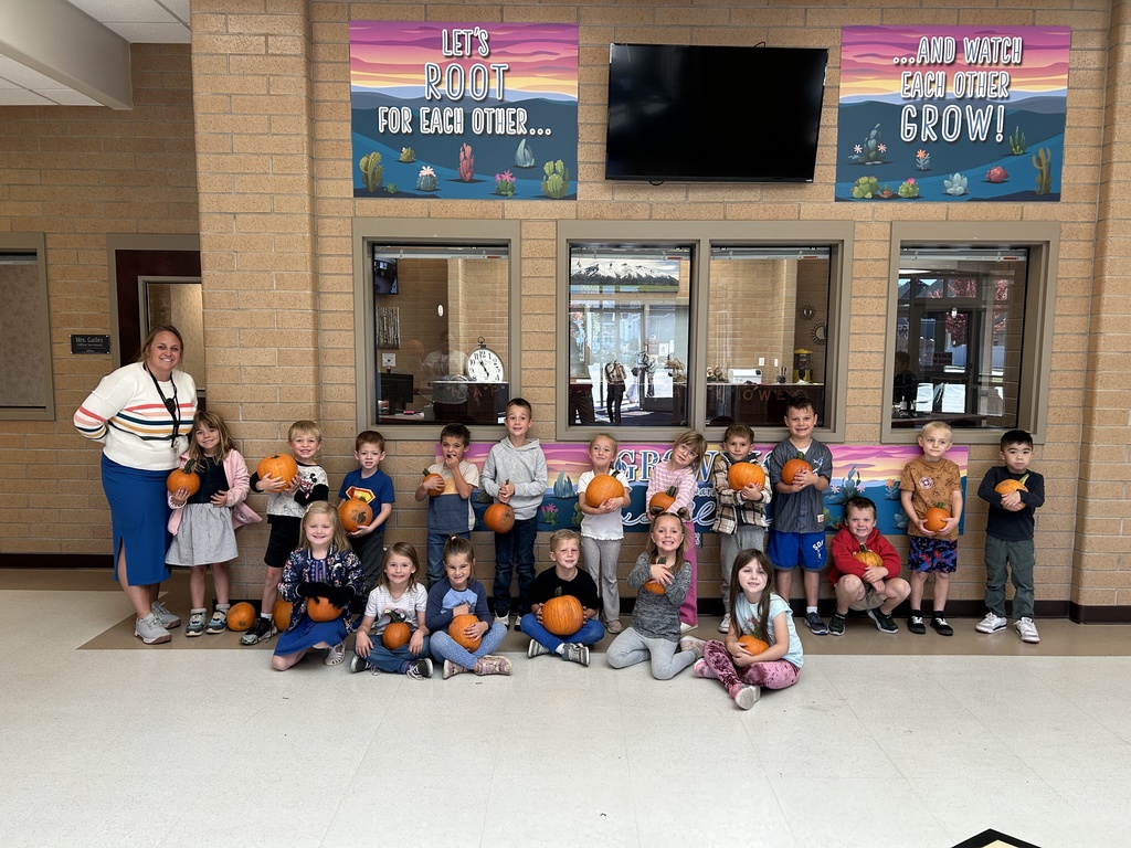 A kindergarten class with their pumpkins. 