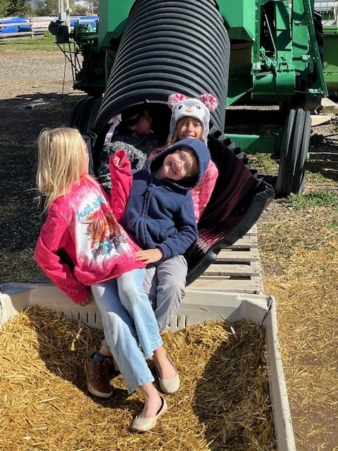 students at the bottom of a tractor slide