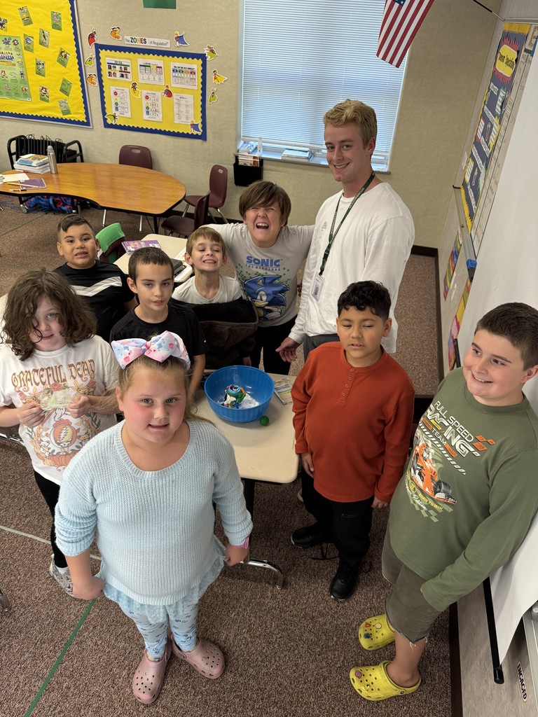 students posing for a photo in their classroom
