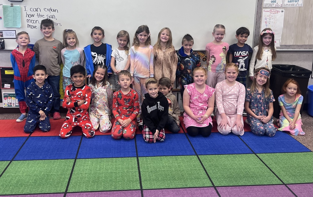first graders smiling for a photo