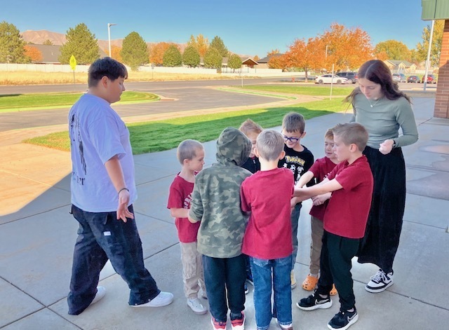 kids with linked hands trying to get out of a knot