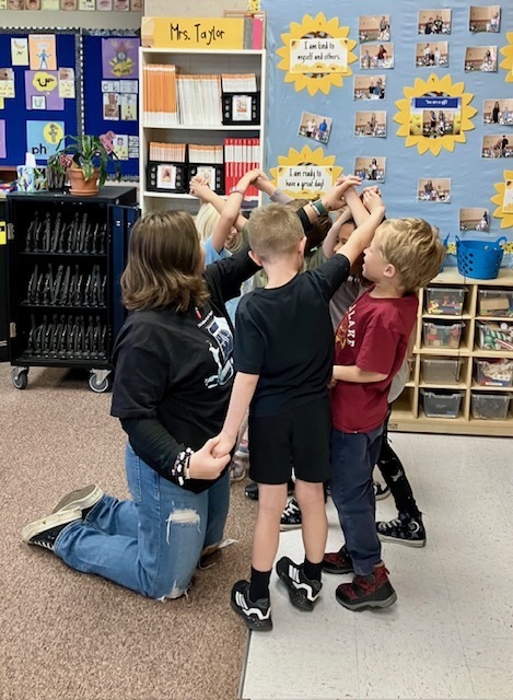 kids with linked hands trying to get out of a knot