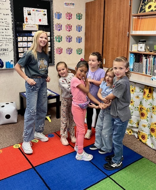 kids with linked hands trying to get out of a knot