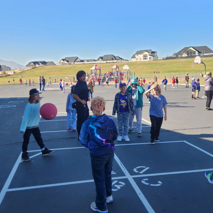 firefighter playing 4 square with kids