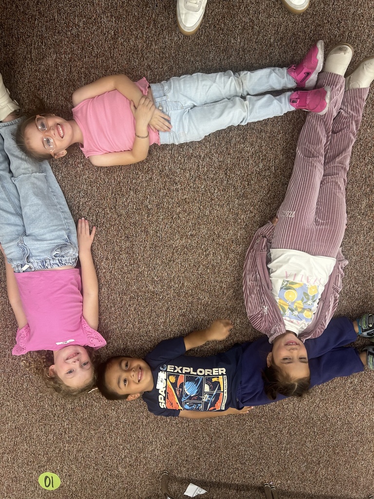 Students posing in a shape