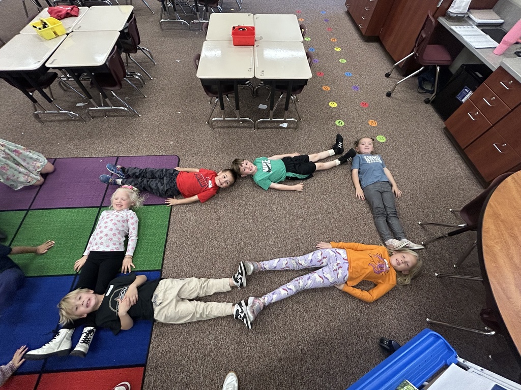 Students posing in a shape