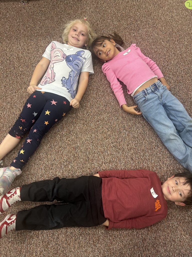 Students posing in a shape