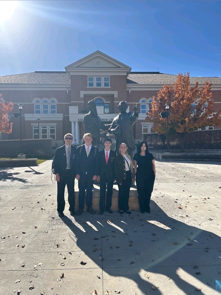 Snow College Invitational Deca-Students in front of statue