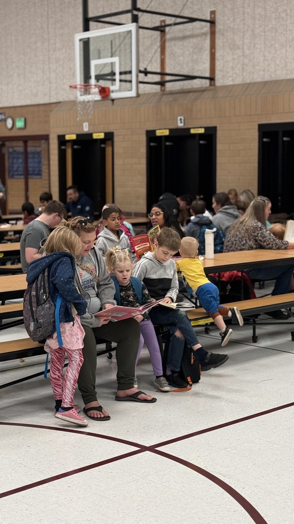 Parents reading books with students