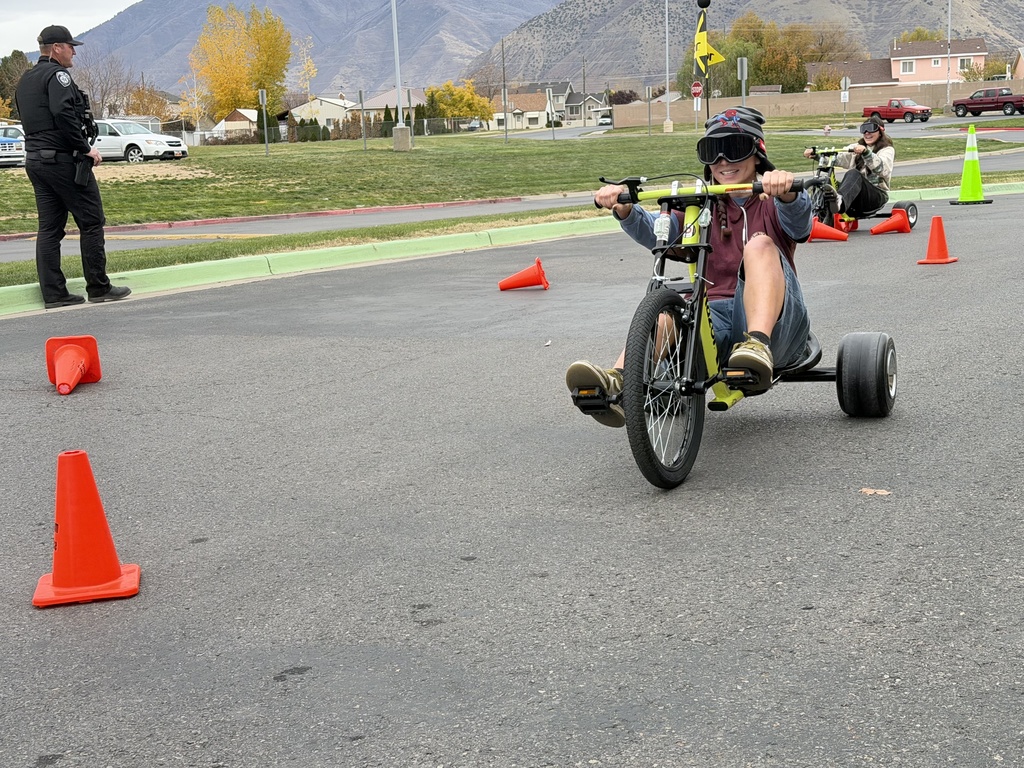 Pizza with the Police Lunchtime Activity- students riding bikes with drunk goggles