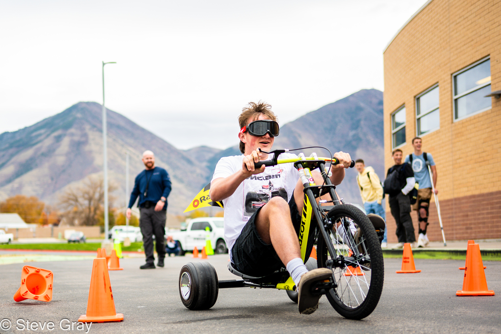 Pizza with the Police Lunchtime Activity- students riding bikes with drunk goggles