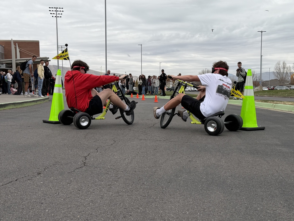 Pizza with the Police Lunchtime Activity- students riding bikes with drunk goggles