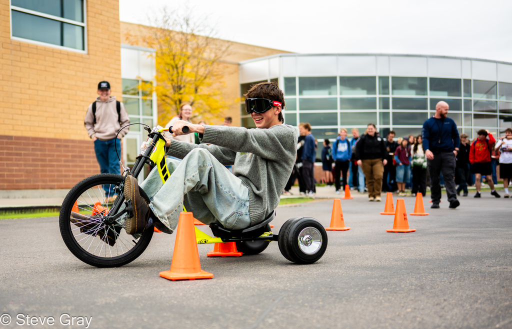 Pizza with the Police Lunchtime Activity- students riding bikes with drunk goggles