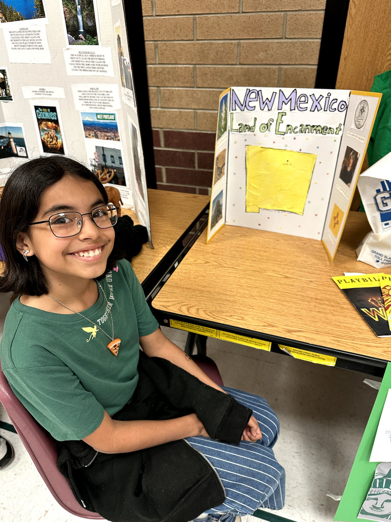 student with poster about New Mexico