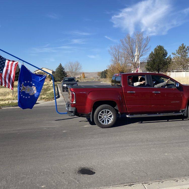 a truck with two flags hanging from it