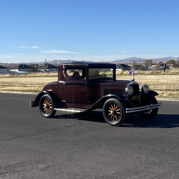 an antique car driving in the parade 