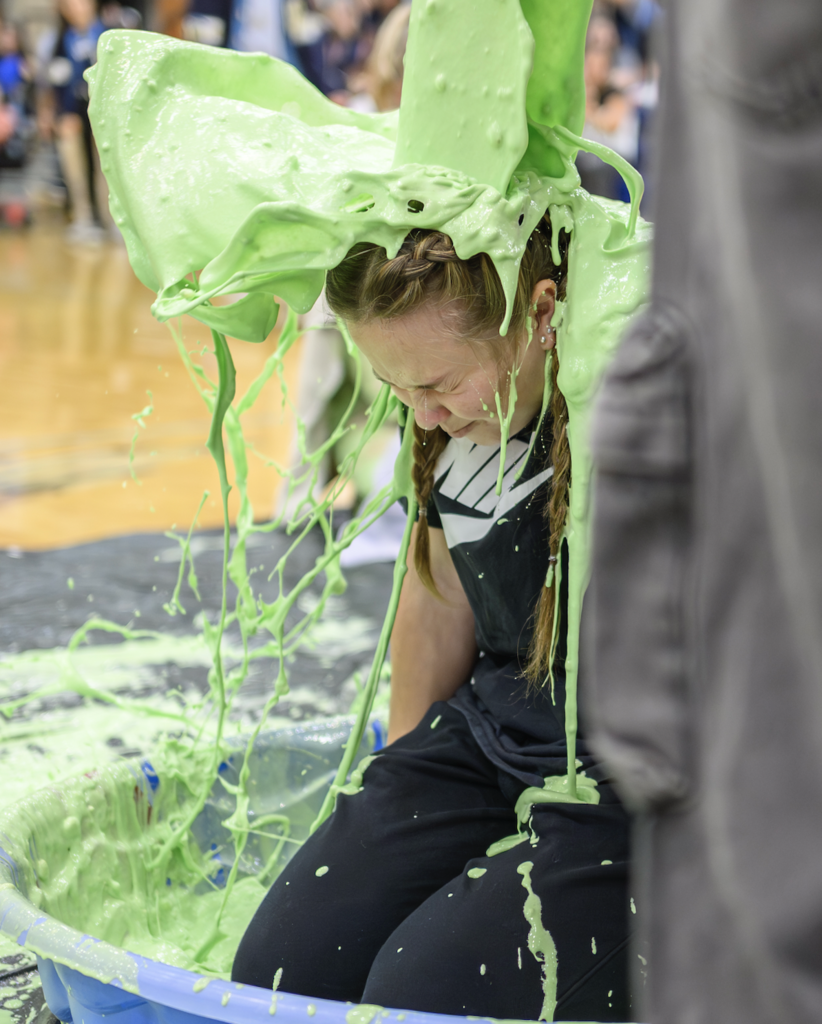 Teacher getting slimed at the Make a Wish Assembly