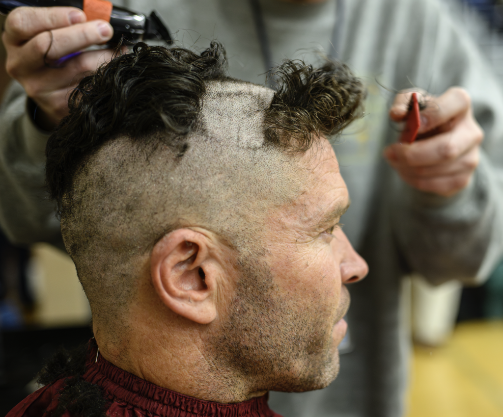 Teacher getting his head shaved in the make a wish assembly